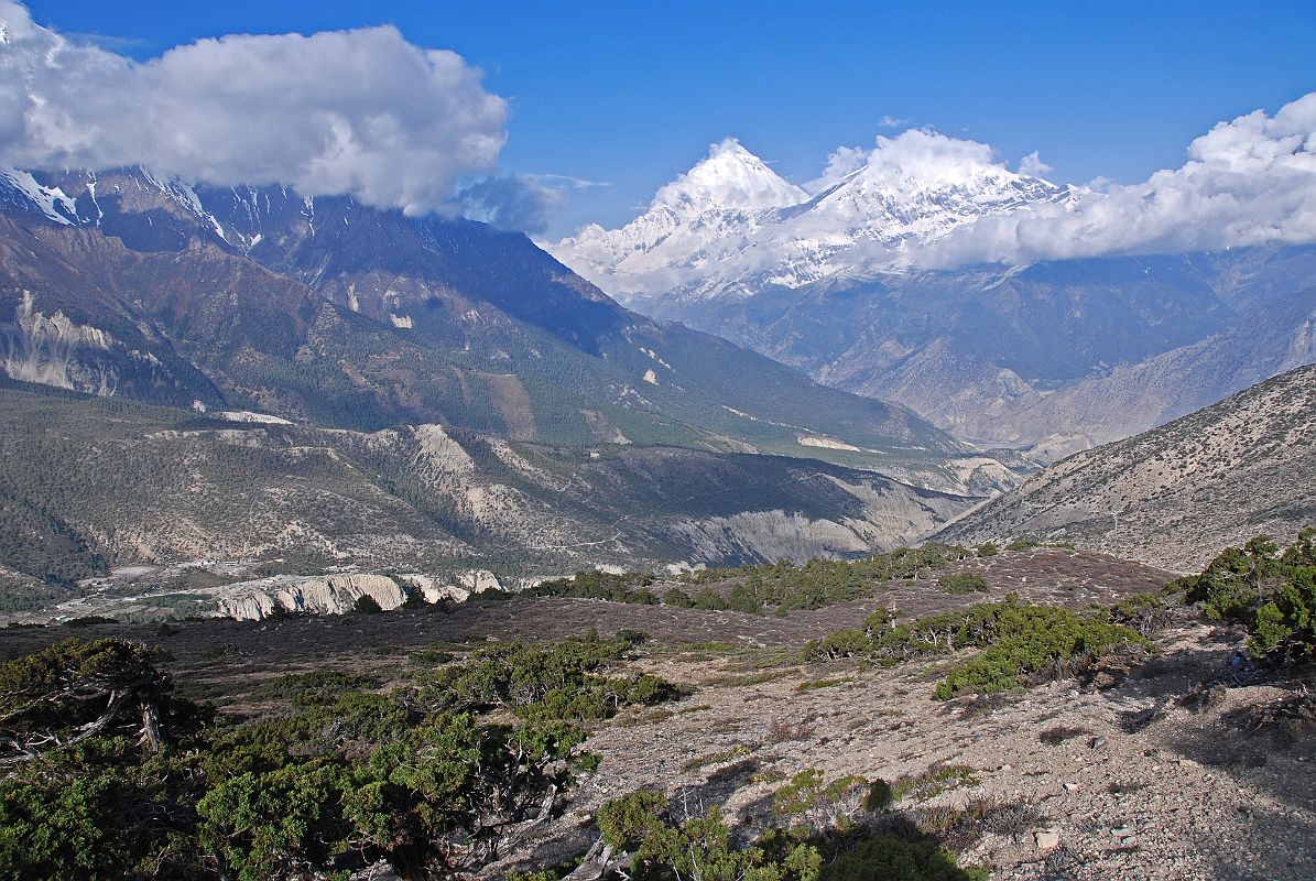 11 Dhaulagiri And Tukuche Peak Early Morning On Trail To Mesokanto La I turned around on the trail towards Mesokanto La and watched the clouds boil up towards Dhaulagiri and Tukuche Peak. The trail continues up the side of the valley from the kharka (3460m) and then splits in two � the left going to the Tilicho eastern pass (5200m), while we took the right path to try and cross the Mesokanto La (5100m).